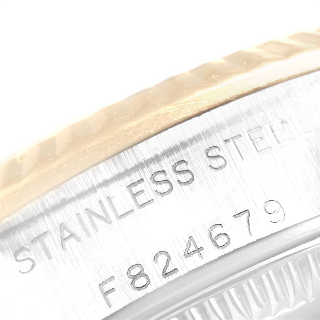 This image shows a close-up of the serial number and "STAINLESS STEEL" engraving on the side of an Oyster Perpetual watch by Rolex.