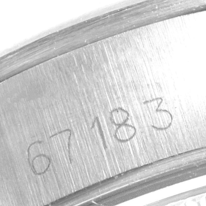 This close-up image shows the engraved serial number (67183) on the case of a Rolex Oyster Perpetual 67183 Women
s Steel and Gold (two tone) Champagne Dial 67183 Women
s Steel and Gold (two tone) Champagne Dial watch.