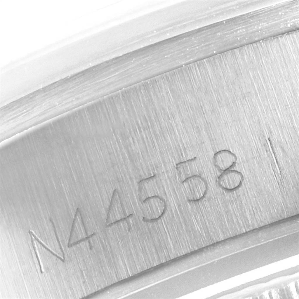 This image shows a close-up of the engraved serial number on the side of a Rolex Oyster Perpetual 67183 Women
s Steel and Gold (two tone) Champagne Dial 67183 Women
s Steel and Gold (two tone) Champagne Dial watch case.