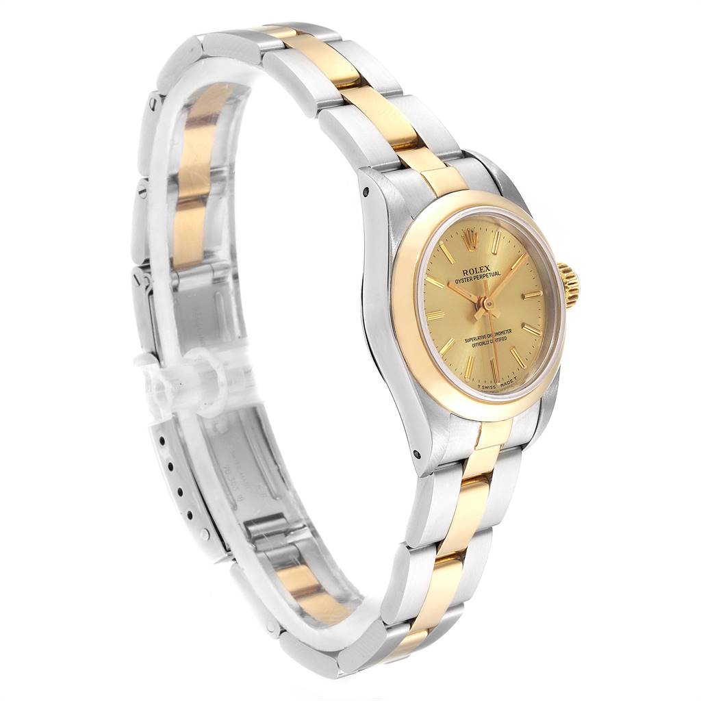 The Rolex Oyster Perpetual 67183 Women
s Steel and Gold (two tone) Champagne Dial 67183 Women
s Steel and Gold (two tone) Champagne Dial watch is shown from a three-quarter angle, highlighting its gold and silver bracelet and face.