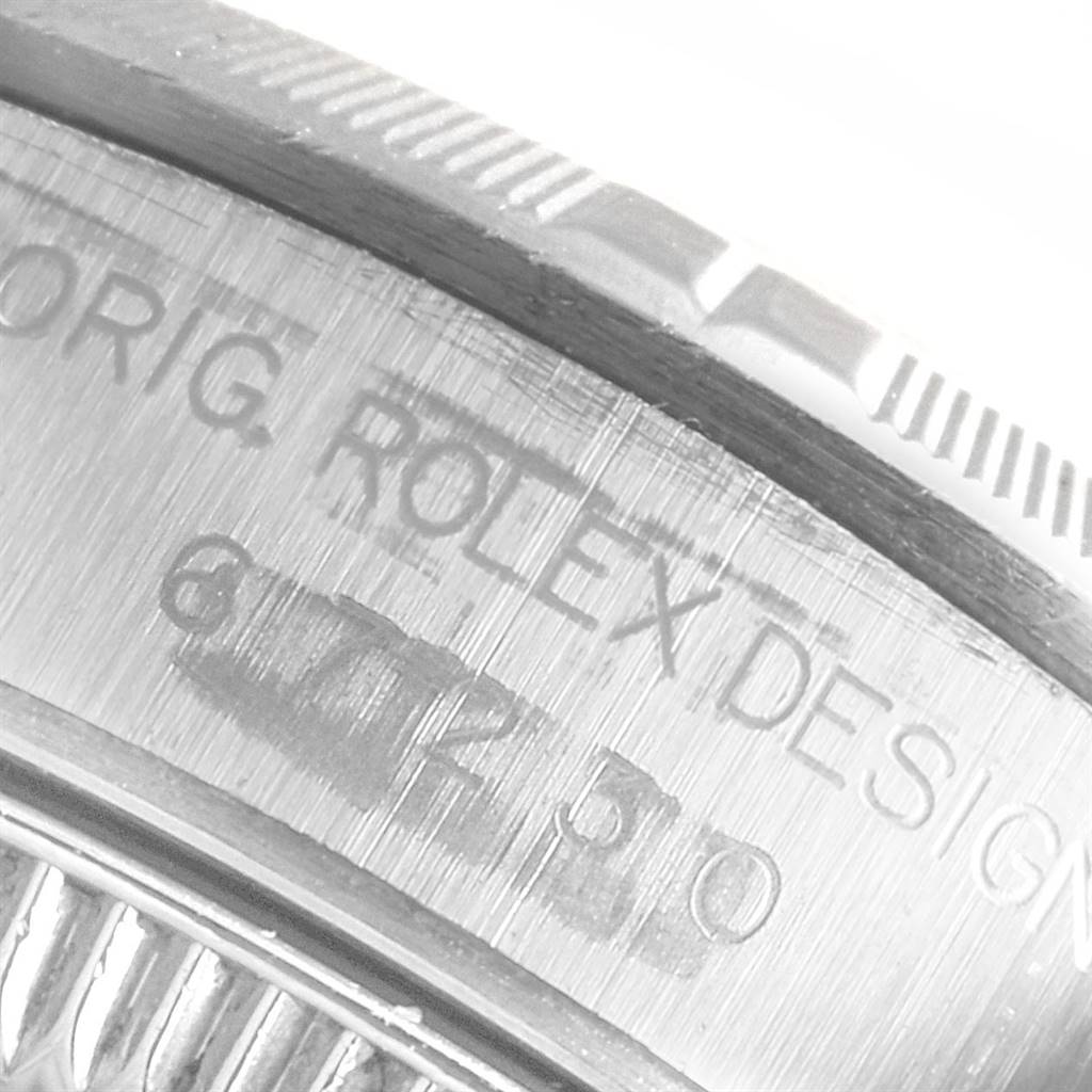 The image shows a close-up of the side engraving and bezel of a Rolex Oyster Perpetual 67230 Women's Stainless Steel Pink Dial 67230 Women's Stainless Steel Pink Dial watch.