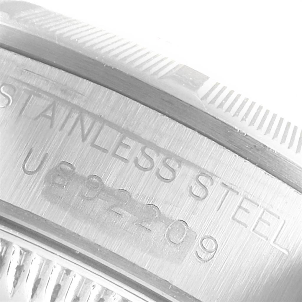 This close-up image shows the edge and engravings on the case back of the Rolex Oyster Perpetual 67230 Women's Stainless Steel Pink Dial 67230 Women's Stainless Steel Pink Dial watch.