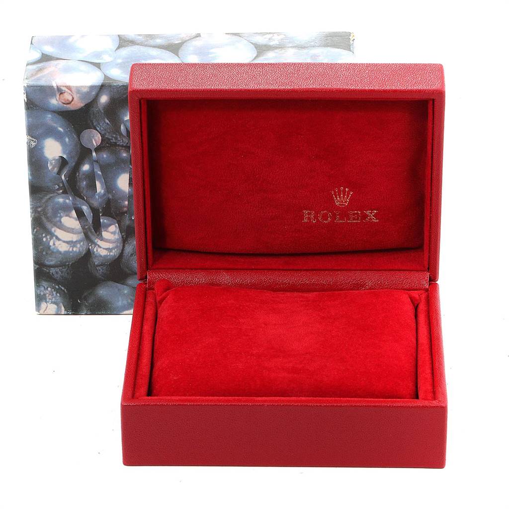 The image shows an open red Rolex watch box, likely for the Oyster Perpetual model, with the logo printed inside the lid.