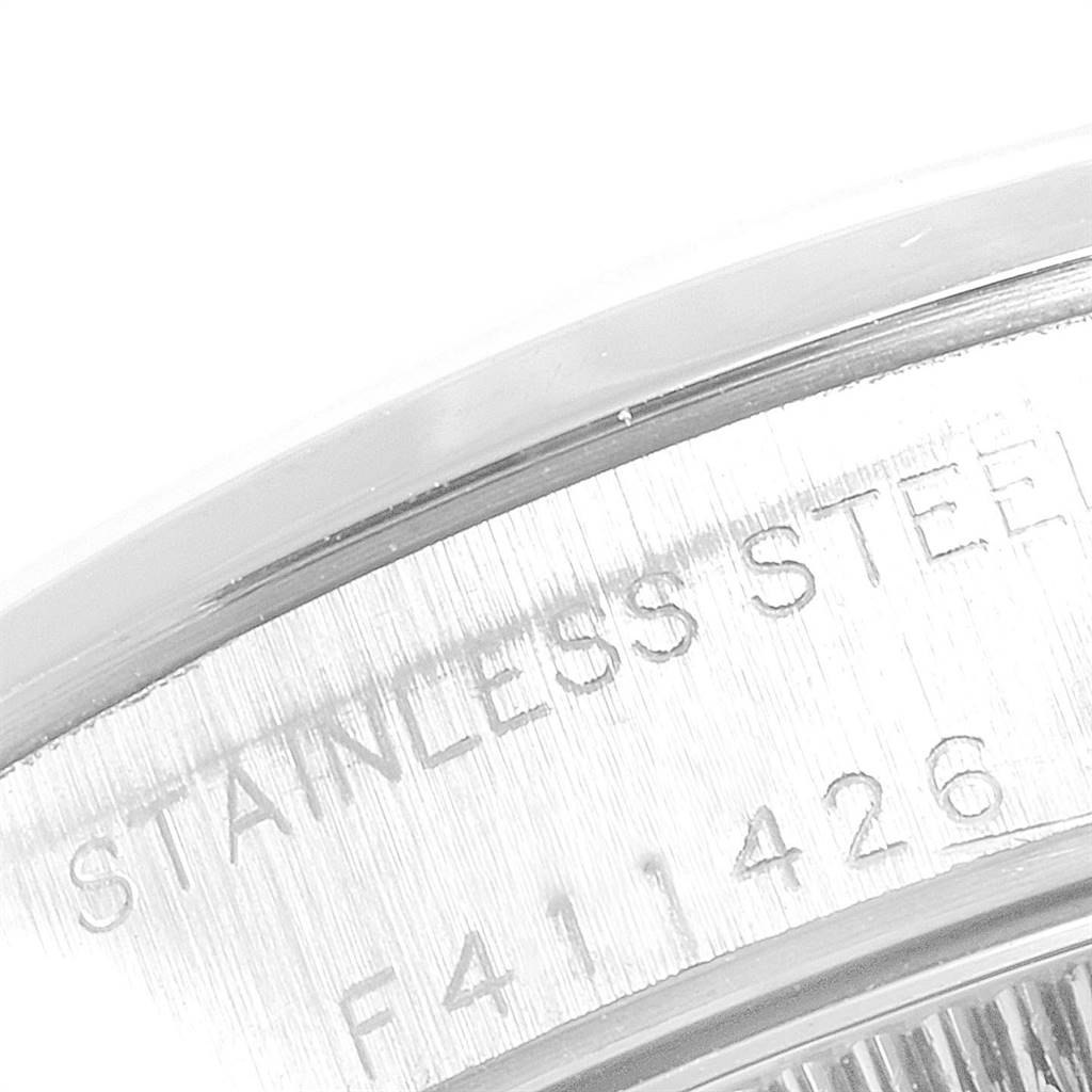 This image shows a close-up of the stainless steel case back with markings on a Rolex Oyster Perpetual 76080 Women's Stainless Steel Black Dial 76080 Women's Stainless Steel Black Dial watch.