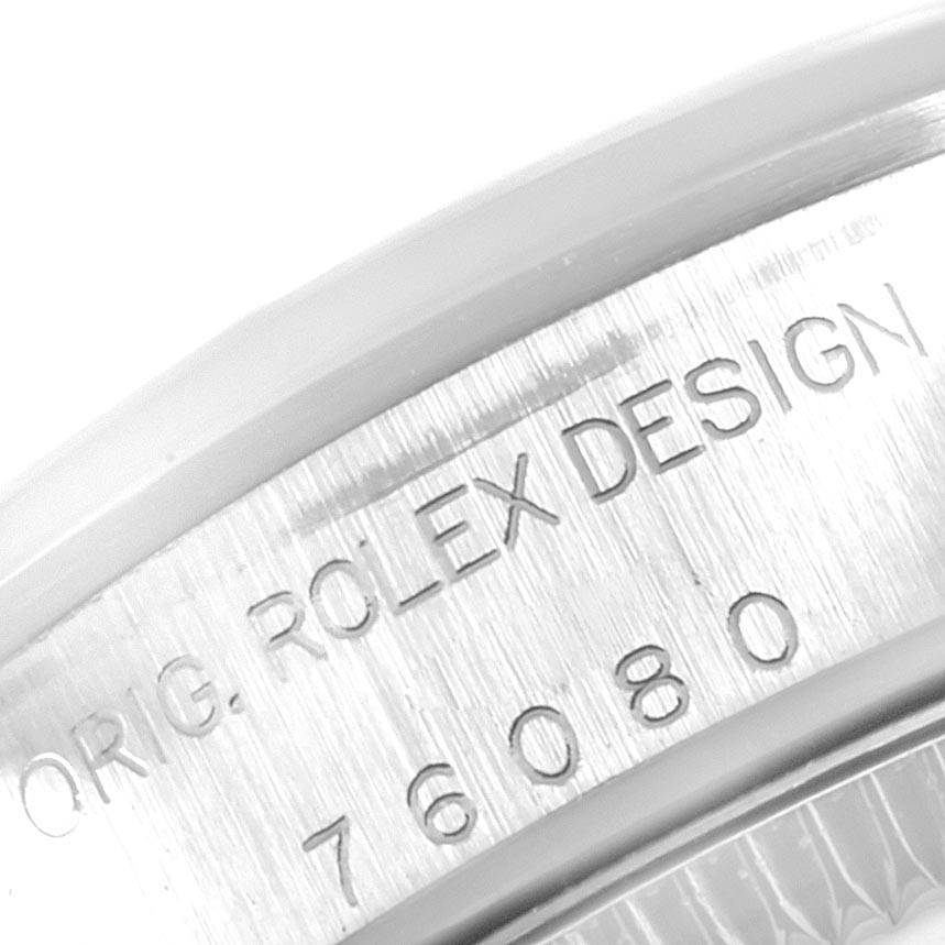 This image shows a close-up of the caseback edge of a Rolex Oyster Perpetual 76080 Women's Stainless Steel Black Dial 76080 Women's Stainless Steel Black Dial watch, displaying the model number and branding.