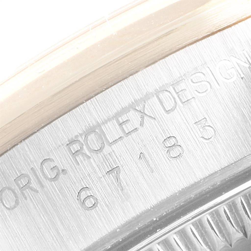 This image shows a close-up of the side casing with engraved details on the Rolex Oyster Perpetual 67183 Women
s Steel and Gold (two tone) Champagne Dial 67183 Women
s Steel and Gold (two tone) Champagne Dial model.