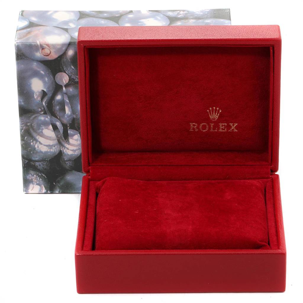The image shows an open red Rolex box for the Oyster Perpetual model, featuring the brand logo on the inside.