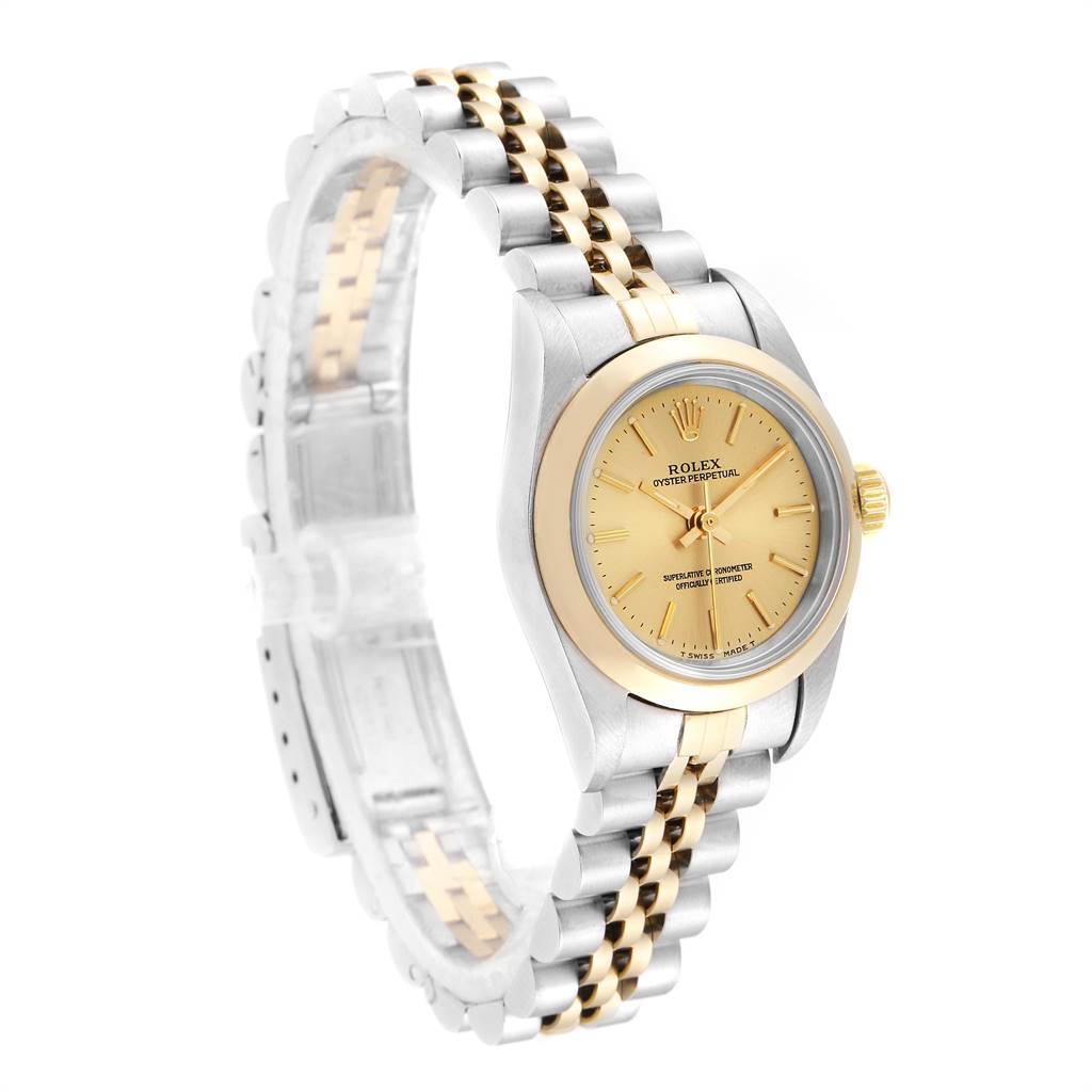 The image shows a Rolex Oyster Perpetual 67183 Women
s Steel and Gold (two tone) Champagne Dial 67183 Women
s Steel and Gold (two tone) Champagne Dial watch at a three-quarter angle, highlighting its two-tone bracelet and champagne dial.