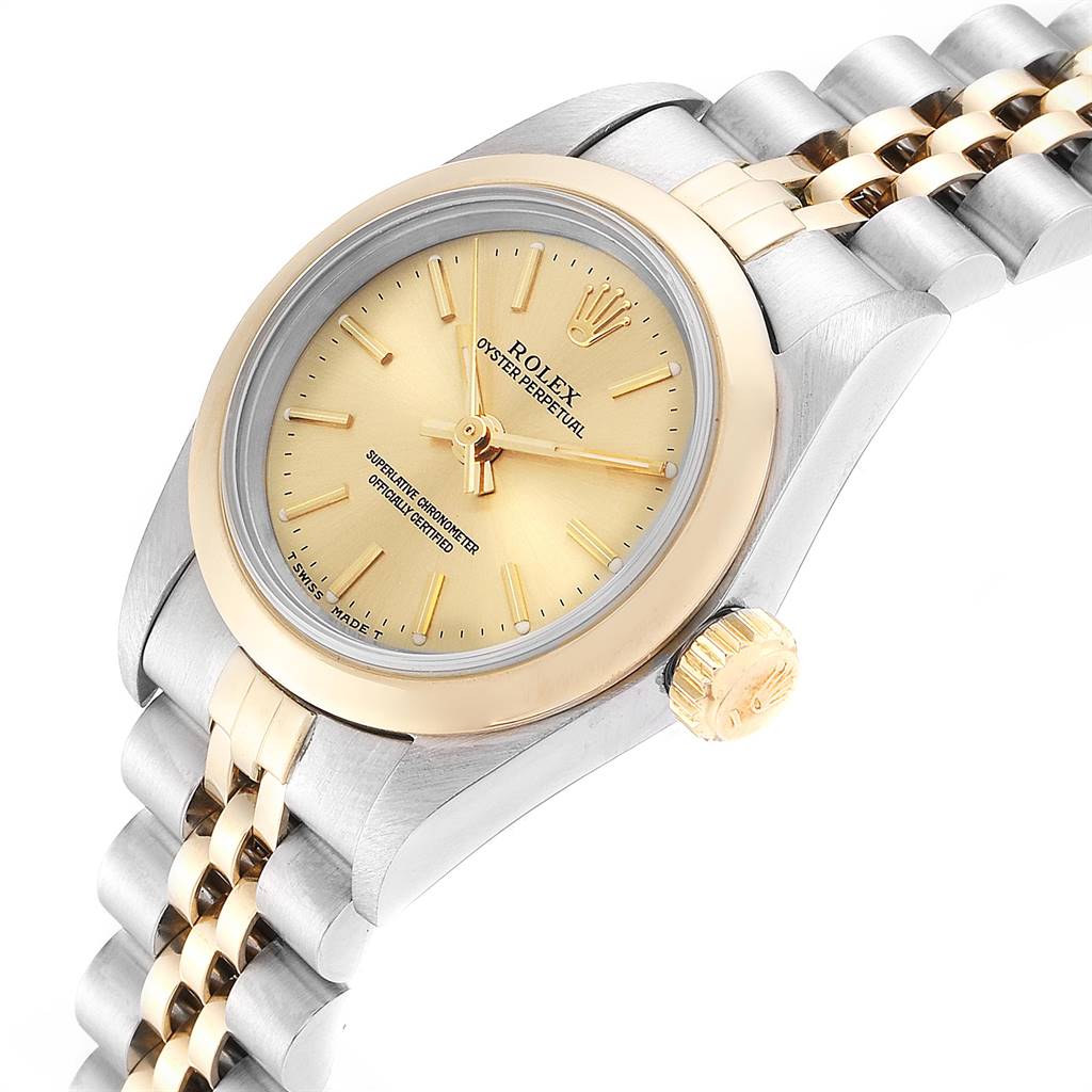 This image shows a Rolex Oyster Perpetual 67183 Women
s Steel and Gold (two tone) Champagne Dial 67183 Women
s Steel and Gold (two tone) Champagne Dial watch from an angled view, highlighting the face, bezel, crown, and part of the bracelet.