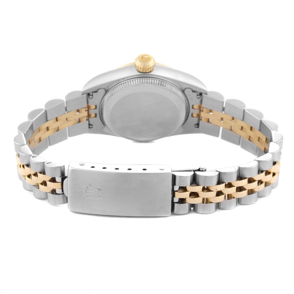 The image shows the back view of a Rolex Oyster Perpetual 67183 Women
s Steel and Gold (two tone) Champagne Dial 67183 Women
s Steel and Gold (two tone) Champagne Dial watch, highlighting the case back, crown, and bi-colored bracelet with clasp.