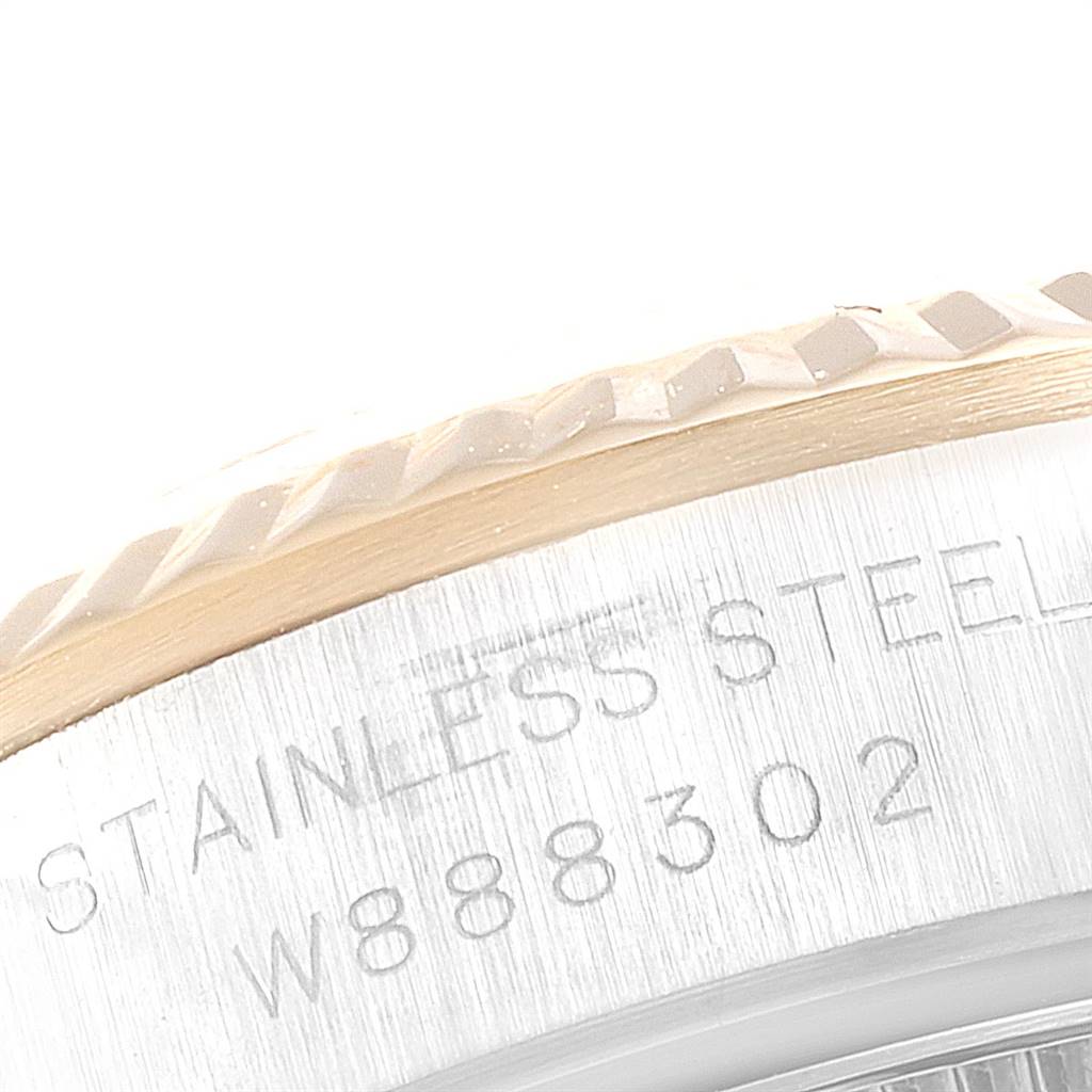 This image shows a close-up of the side of the Rolex Oyster Perpetual 67193 Women
s Steel and Gold (two tone) White Dial 67193 Women
s Steel and Gold (two tone) White Dial watch, highlighting the stainless steel material and engraved serial number.