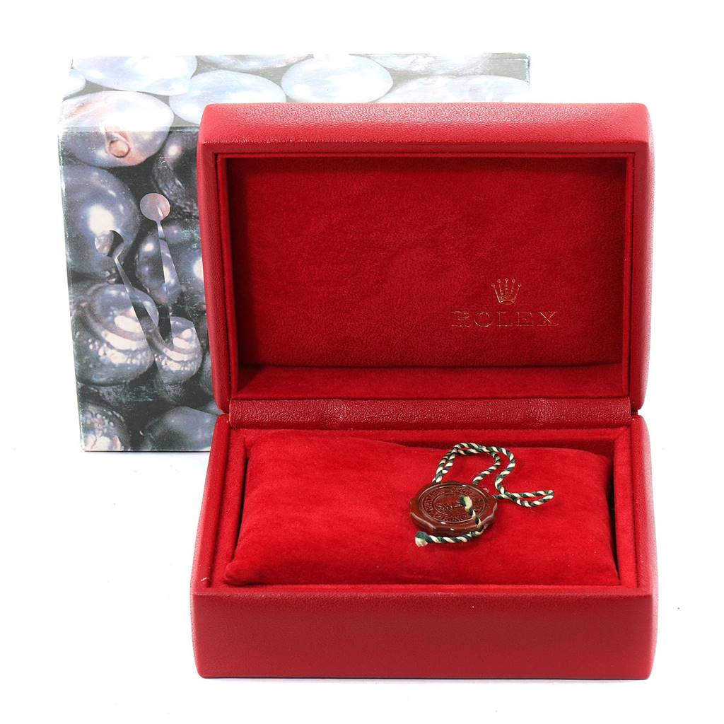 The image shows a red Rolex watch box for an Oyster Perpetual model, containing a hang tag but no watch visible.