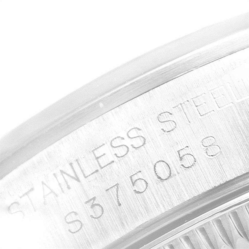 This image shows a close-up of the side of a Rolex Oyster Perpetual 67180 Women
s Stainless Steel Blue Dial 67180 Women
s Stainless Steel Blue Dial watch, highlighting its stainless steel material and serial number.
