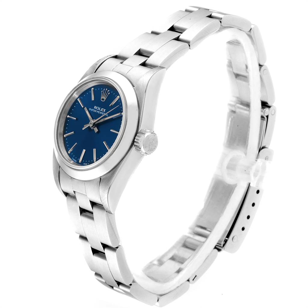 The Rolex Oyster Perpetual 67180 Women
s Stainless Steel Blue Dial 67180 Women
s Stainless Steel Blue Dial watch is shown at a three-quarter angle, highlighting its blue dial, crown, and stainless steel bracelet.
