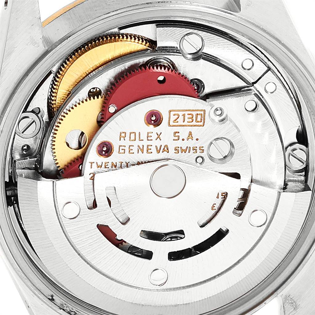 This image shows the internal movement mechanism of a Rolex Oyster Perpetual 67193 Women's Steel and Gold (two tone) Silver Dial 67193 Women's Steel and Gold (two tone) Silver Dial watch, highlighting its gears and Swiss craftsmanship details.