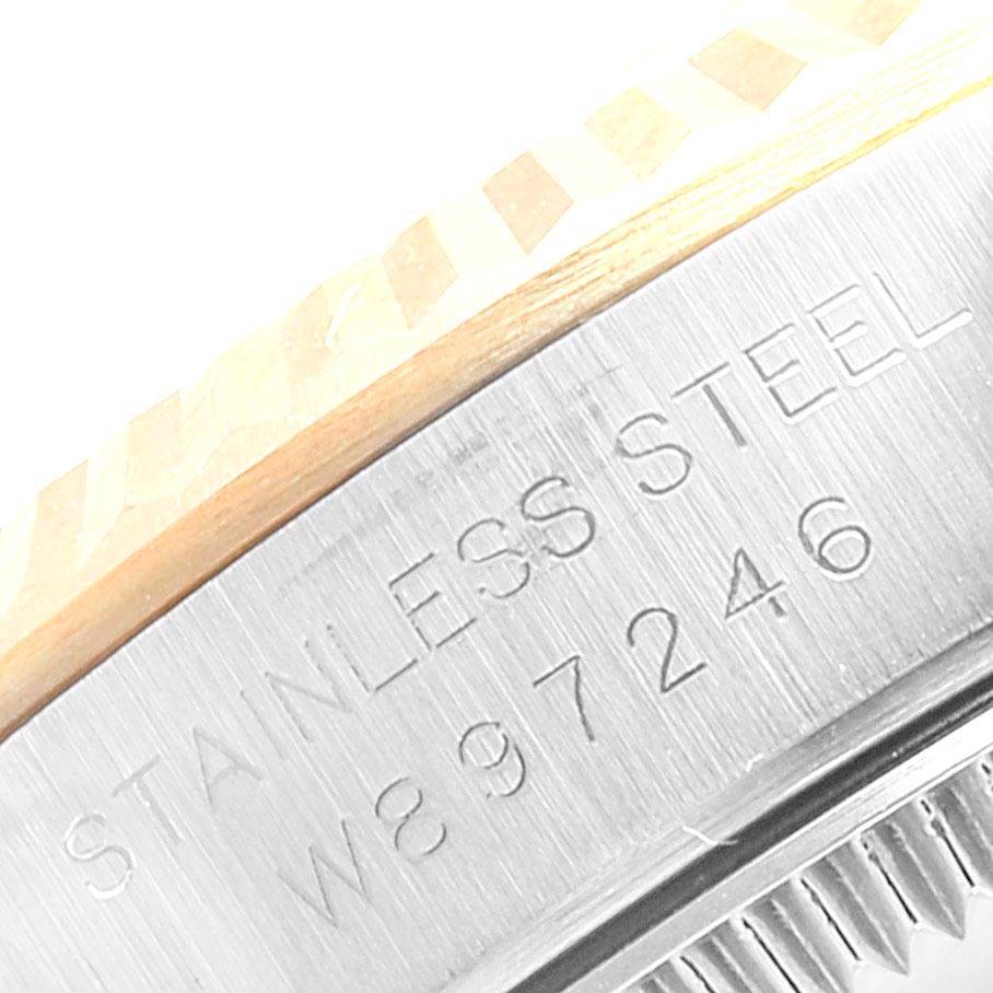 The image shows a close-up of the side of a stainless steel Rolex Oyster Perpetual 67193 Women
s Steel and Gold (two tone) Champagne Dial 67193 Women
s Steel and Gold (two tone) Champagne Dial watch, highlighting the engraved serial number.