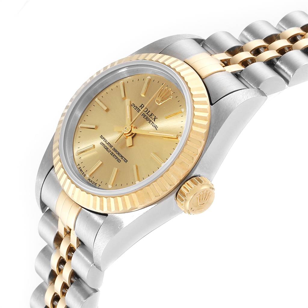 The image shows a side angle of the Rolex Oyster Perpetual 67193 Women
s Steel and Gold (two tone) Champagne Dial 67193 Women
s Steel and Gold (two tone) Champagne Dial watch, highlighting the dial, fluted bezel, crown, and part of the bracelet.