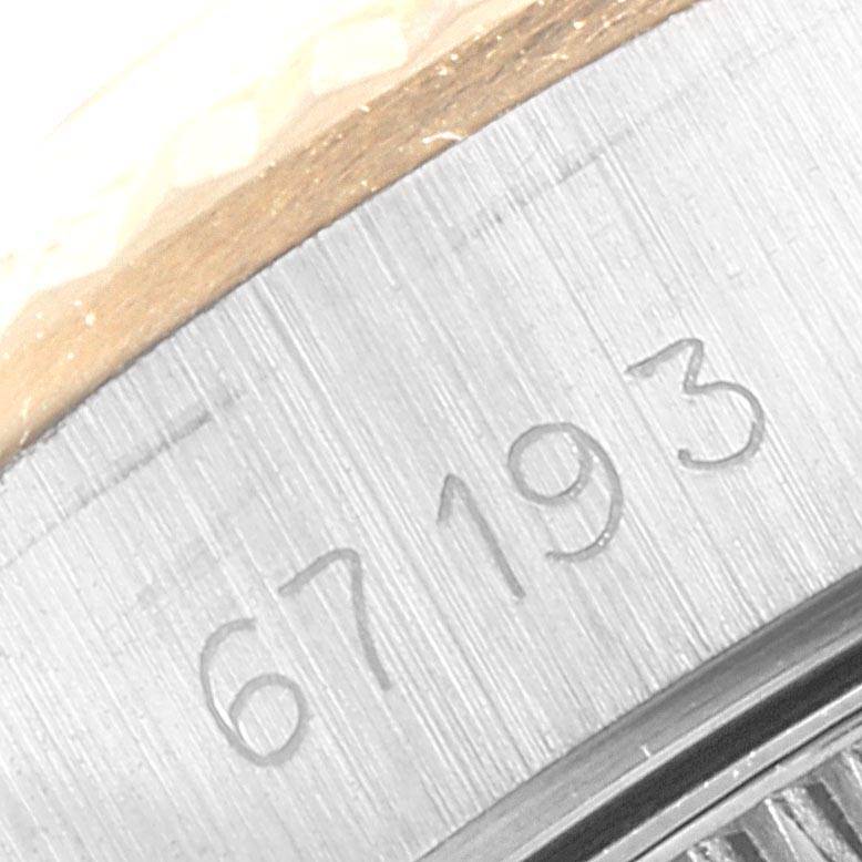 The close-up image shows the serial number engraving on the case back of a Rolex Oyster Perpetual 67193 Women
s Steel and Gold (two tone) Champagne Dial 67193 Women
s Steel and Gold (two tone) Champagne Dial watch.