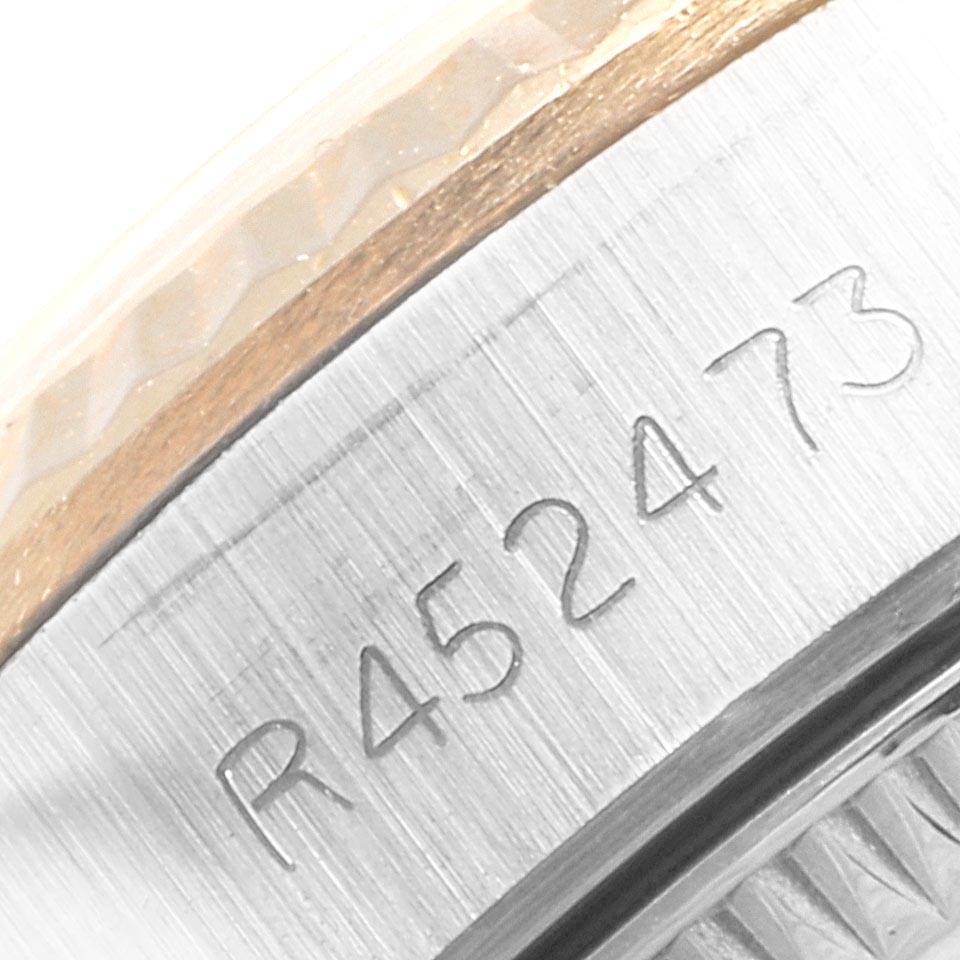 This close-up image shows the engraved serial number on the casing of a Rolex Oyster Perpetual 67193 Women
s Steel and Gold (two tone) Champagne Dial 67193 Women
s Steel and Gold (two tone) Champagne Dial watch.