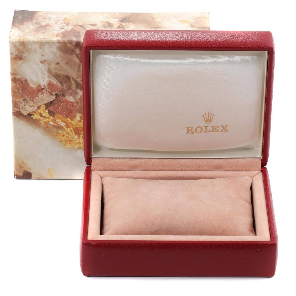 This image shows an open red Rolex box for an Oyster Perpetual model, with the inside pillow and branded lid visible.