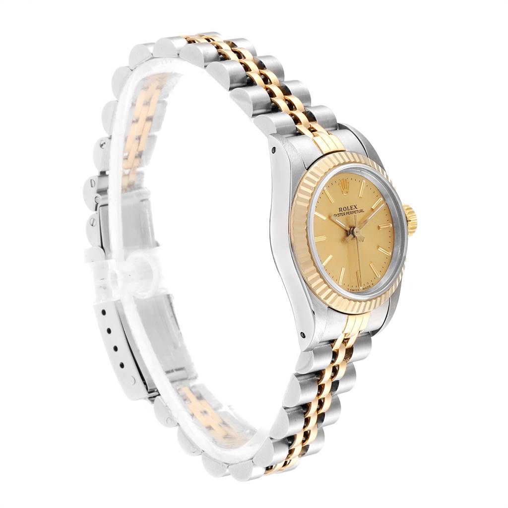 The image shows a side view of the Rolex Oyster Perpetual 67193 Women
s Steel and Gold (two tone) Champagne Dial 67193 Women
s Steel and Gold (two tone) Champagne Dial watch, highlighting the two-tone bracelet and gold bezel.