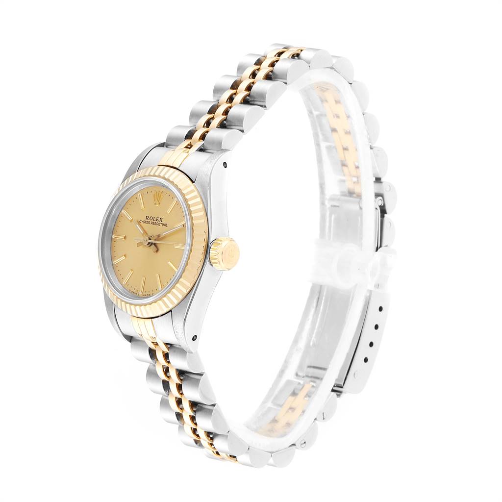 This Rolex Oyster Perpetual 67193 Women
s Steel and Gold (two tone) Champagne Dial 67193 Women
s Steel and Gold (two tone) Champagne Dial watch is shown at an angle highlighting the dial, crown, and two-tone bracelet.
