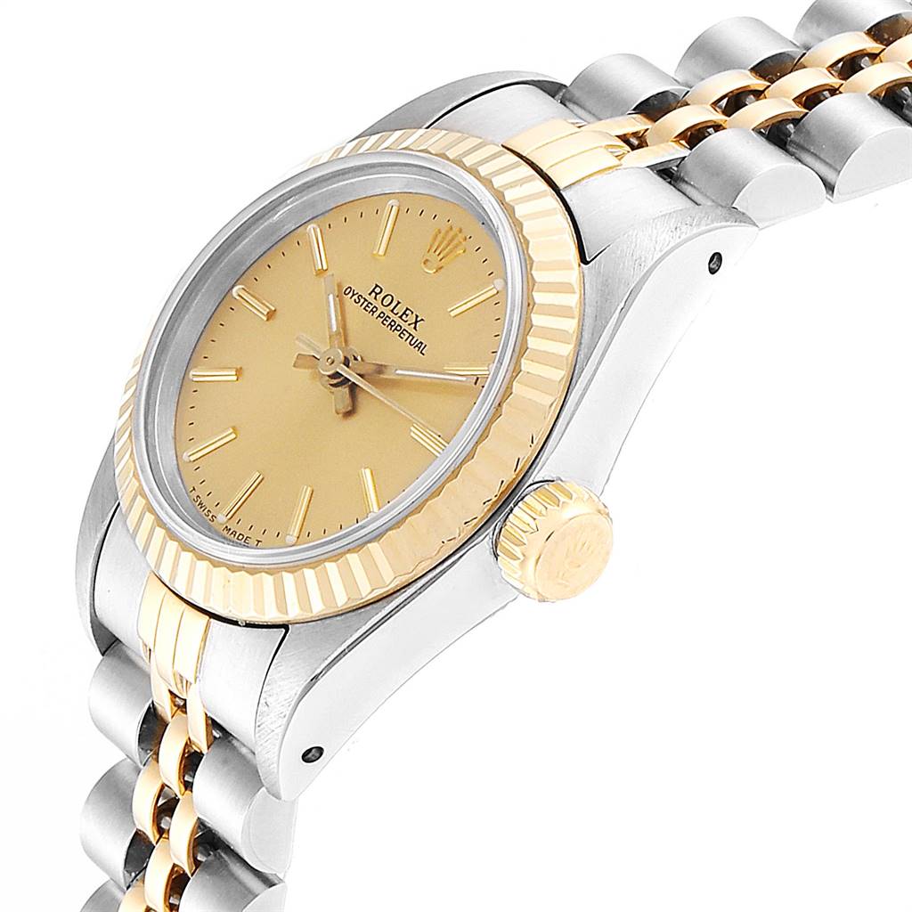 The image shows the side profile and part of the bracelet of a Rolex Oyster Perpetual 67193 Women
s Steel and Gold (two tone) Champagne Dial 67193 Women
s Steel and Gold (two tone) Champagne Dial watch, highlighting the crown and two-tone design.