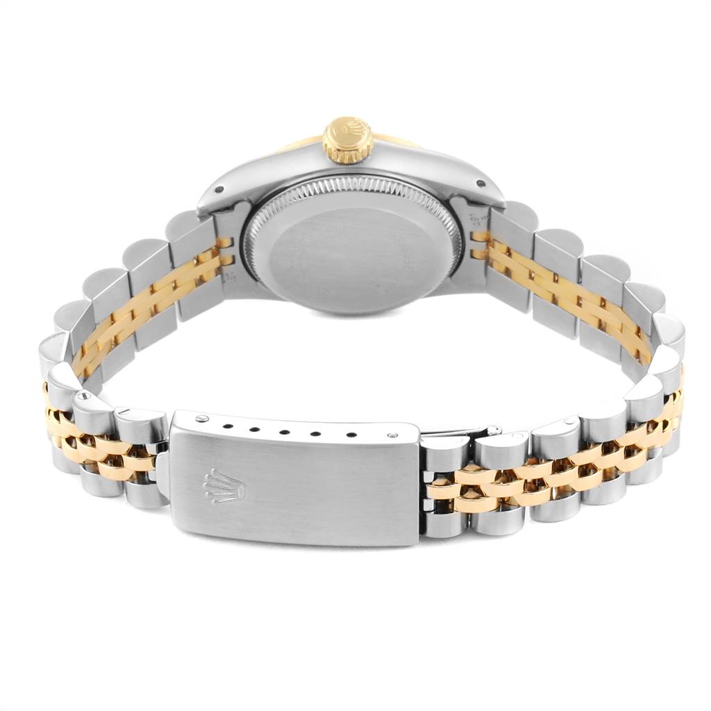 The image shows the back view of a Rolex Oyster Perpetual 67193 Women
s Steel and Gold (two tone) Champagne Dial 67193 Women
s Steel and Gold (two tone) Champagne Dial watch, highlighting its clasp, bracelet, and case back.