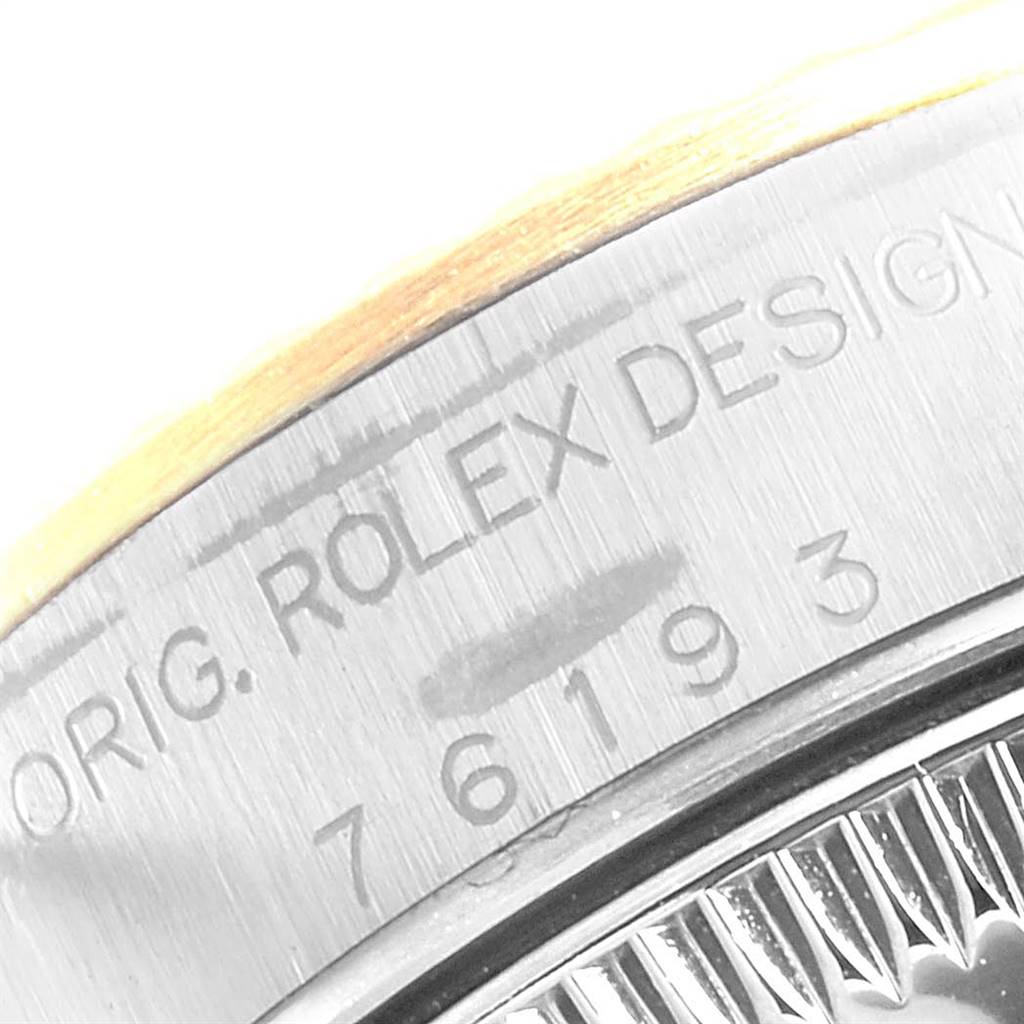 This close-up image shows the side engraving and part of the bezel on a Rolex Oyster Perpetual 76193 Women
s Steel and Gold (two tone) Black Dial 76193 Women
s Steel and Gold (two tone) Black Dial watch.