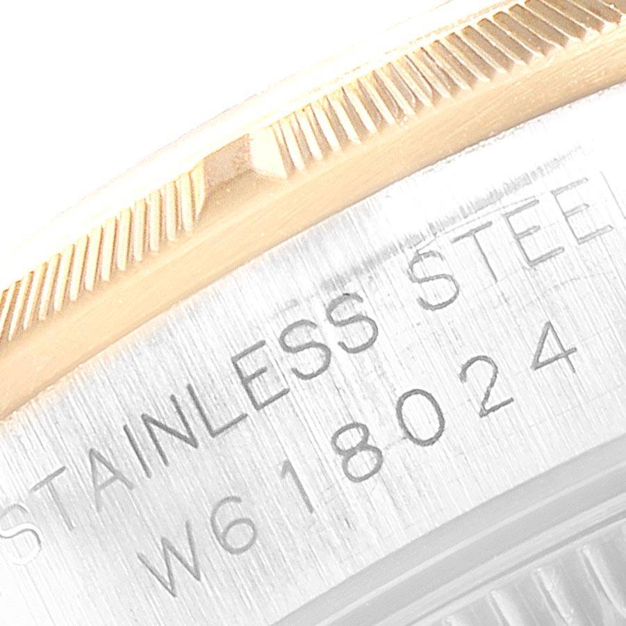 This close-up image shows the side view of the bezel and case edge with engravings of the Rolex Oyster Perpetual 67233 Women's Steel and Gold (two tone) Grey Dial 67233 Women's Steel and Gold (two tone) Grey Dial watch.