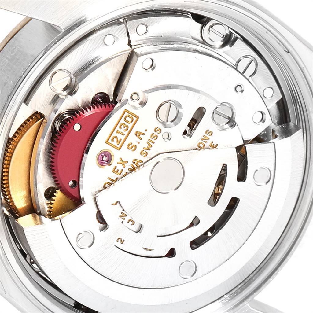 The image shows the movement mechanism of a Rolex Oyster Perpetual 67233 Women's Steel and Gold (two tone) Grey Dial 67233 Women's Steel and Gold (two tone) Grey Dial watch, focused on gears and internal components.