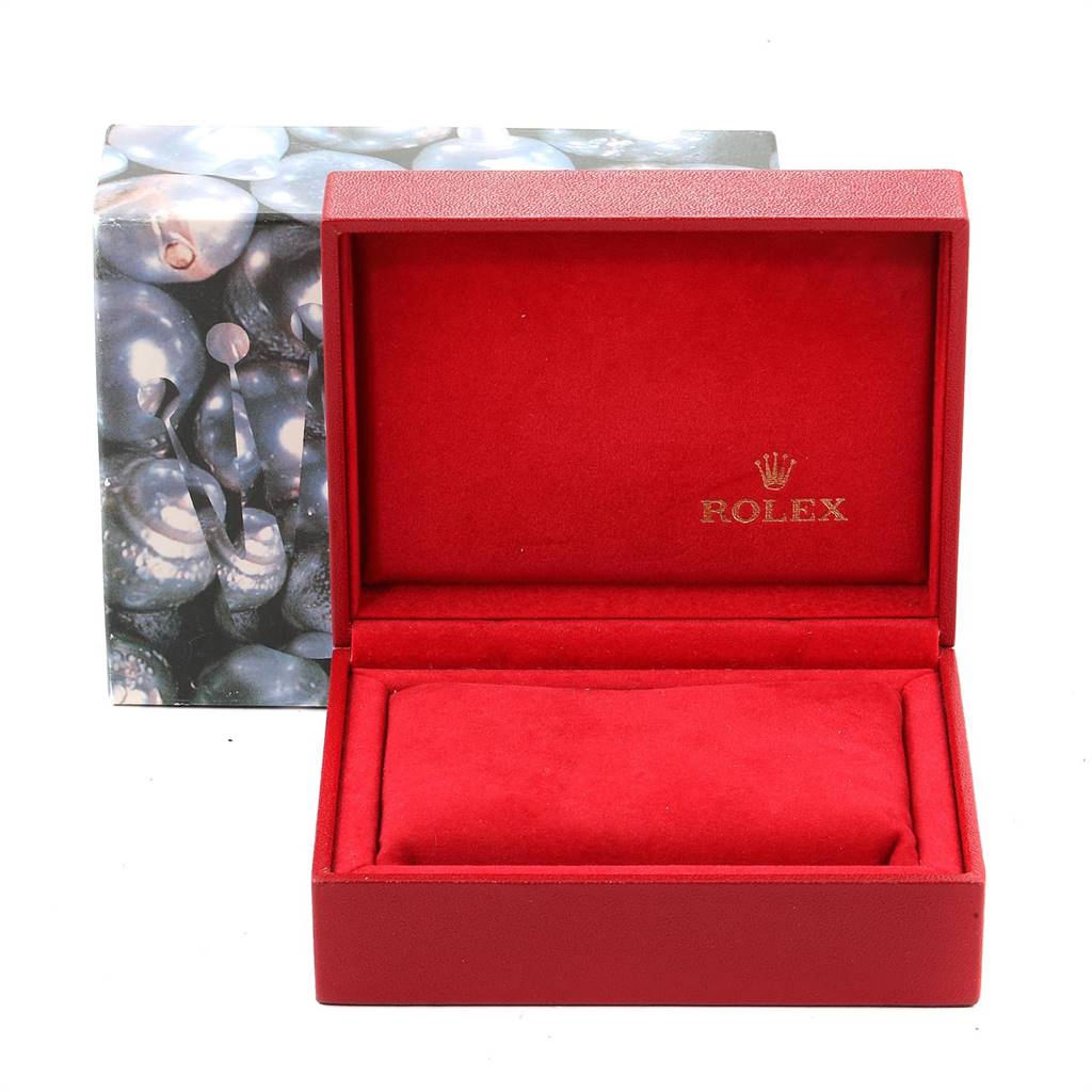 This image shows an empty red Rolex Oyster Perpetual 67233 Women's Steel and Gold (two tone) Grey Dial 67233 Women's Steel and Gold (two tone) Grey Dial watch box from a front angle, with Rolex branding inside the lid.