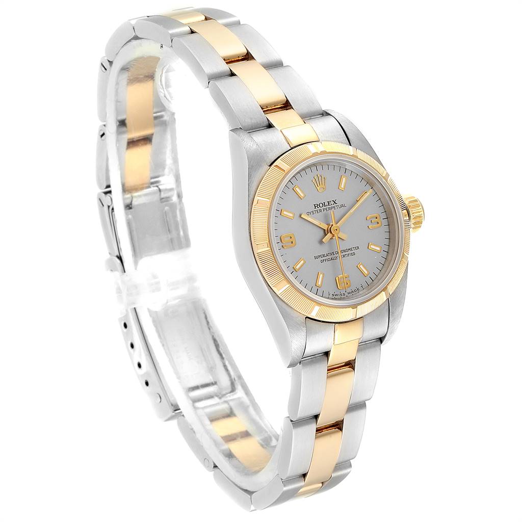 The image shows a side angle view of an Oyster Perpetual Rolex watch, highlighting the face, bezel, and two-tone bracelet.