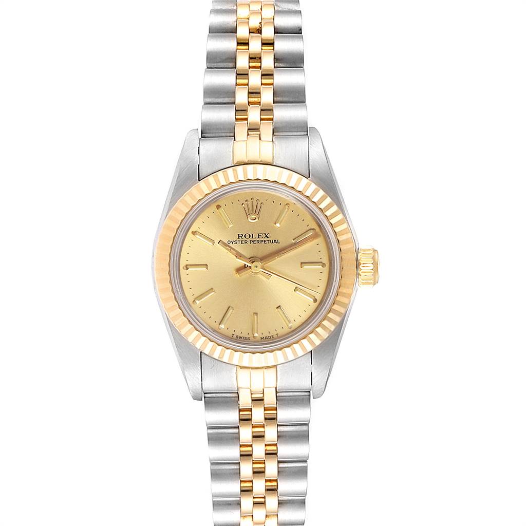 The image shows a front view of a Rolex Oyster Perpetual 67193 Women
s Steel and Gold (two tone) Champagne Dial 67193 Women
s Steel and Gold (two tone) Champagne Dial watch with a gold dial, fluted bezel, and two-tone metal bracelet.