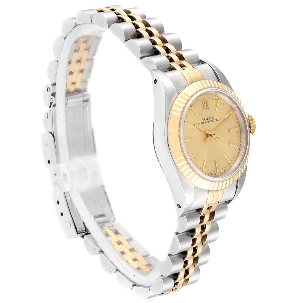 The Rolex Oyster Perpetual 67193 Women
s Steel and Gold (two tone) Champagne Dial 67193 Women
s Steel and Gold (two tone) Champagne Dial watch is shown at a three-quarter angle, displaying the face, fluted bezel, and two-tone bracelet.