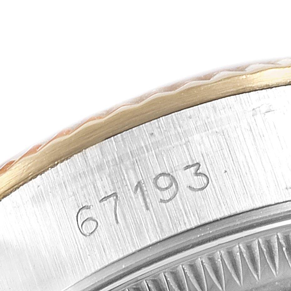 This image shows a close-up of the engraved case side of a Rolex Oyster Perpetual 67193 Women
s Steel and Gold (two tone) Champagne Dial 67193 Women
s Steel and Gold (two tone) Champagne Dial watch, model number 67193.