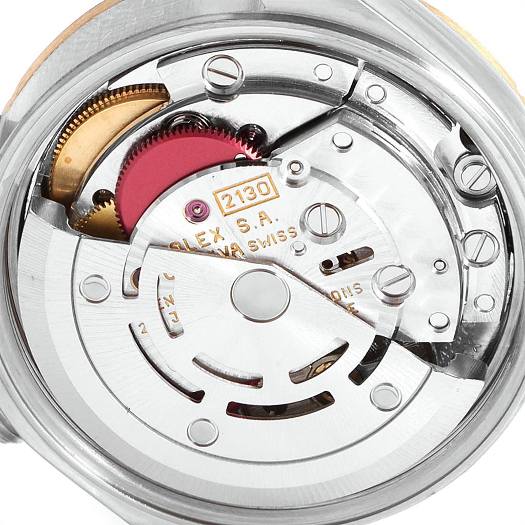 The image shows a close-up view of the movement mechanism inside a Rolex Oyster Perpetual 67243 Women
s Steel and Gold (two tone) Champagne Dial 67243 Women
s Steel and Gold (two tone) Champagne Dial watch.