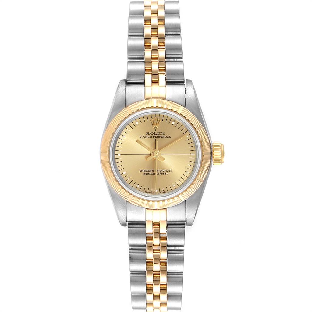 The image shows a frontal view of a Rolex Oyster Perpetual 67243 Women
s Steel and Gold (two tone) Champagne Dial 67243 Women
s Steel and Gold (two tone) Champagne Dial watch, featuring its dial, bezel, and two-tone bracelet.
