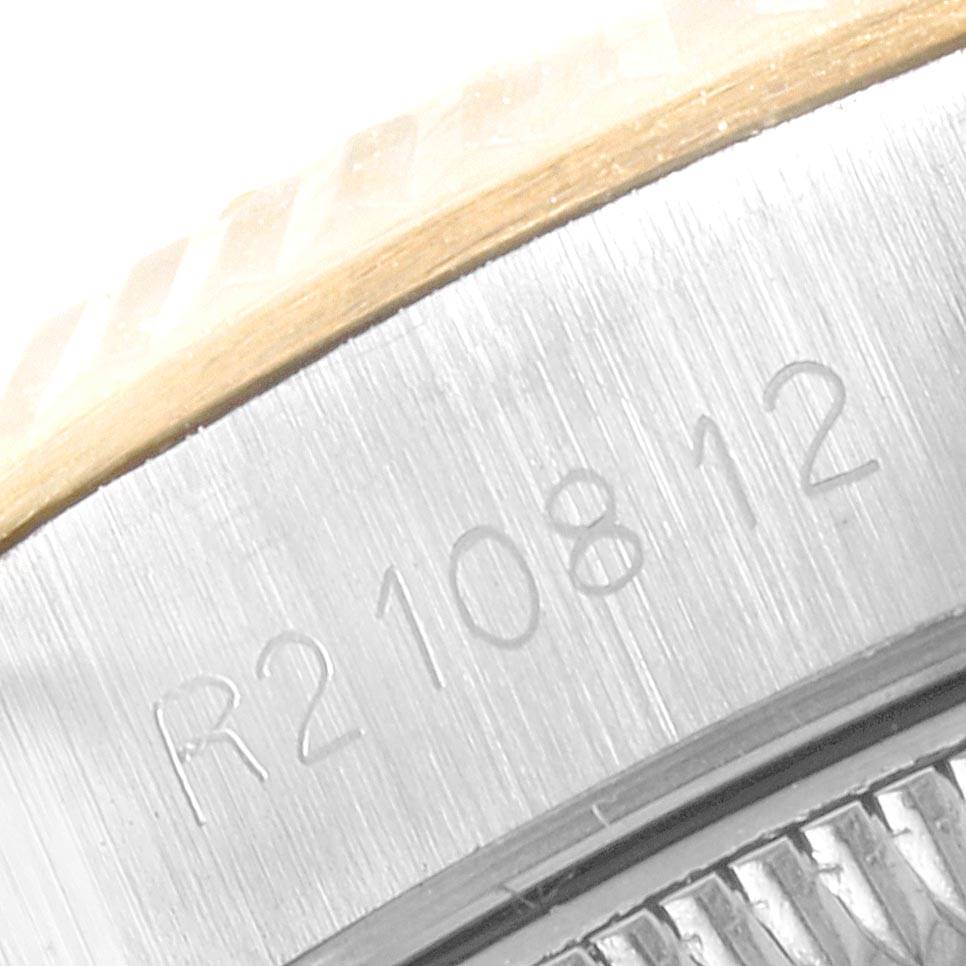 This close-up image shows a partial view of the serial number on the side case of a Rolex Oyster Perpetual 67193 Women
s Steel and Gold (two tone) Champagne Dial 67193 Women
s Steel and Gold (two tone) Champagne Dial watch.