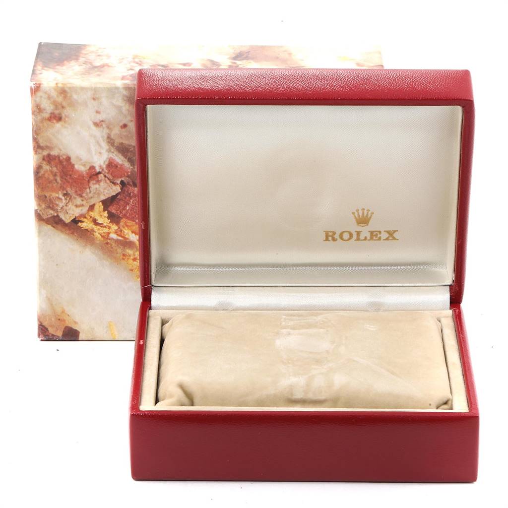 The image shows an open Rolex box for an Oyster Perpetual model, displaying the interior cushion and lid.