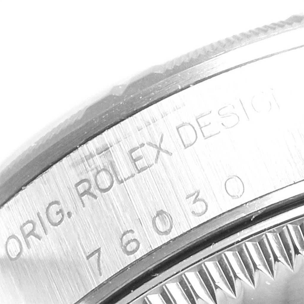 The image shows a close-up side view of the bezel and case with engraved text on a Rolex Oyster Perpetual 76030 Women
s Stainless Steel Pink Dial 76030 Women
s Stainless Steel Pink Dial watch.