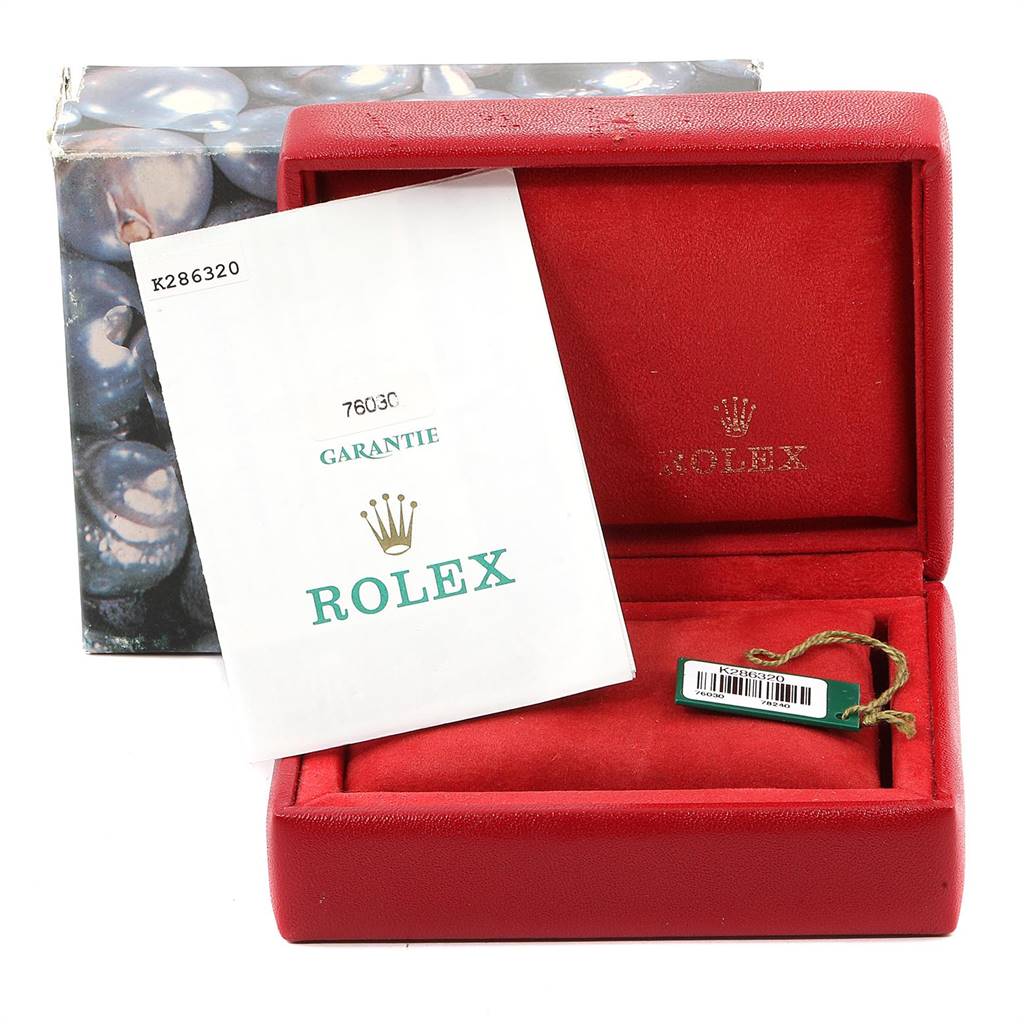 This image shows the packaging, warranty booklet, and tag for a Rolex Oyster Perpetual 76030 Women
s Stainless Steel Pink Dial 76030 Women
s Stainless Steel Pink Dial watch.