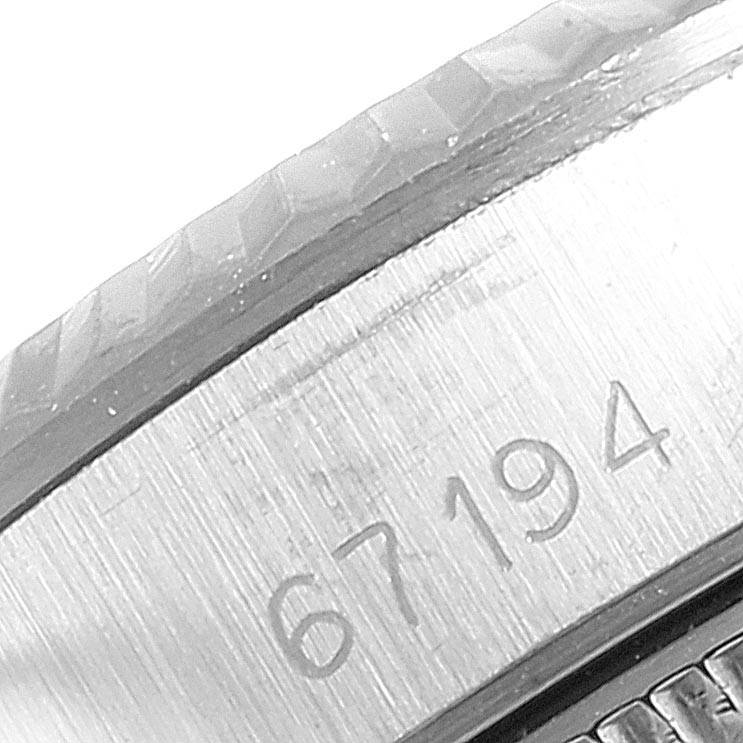 This image shows a close-up of the serial number and the bezel of the Rolex Oyster Perpetual 67194 Women's Stainless Steel Silver Dial 67194 Women's Stainless Steel Silver Dial watch.
