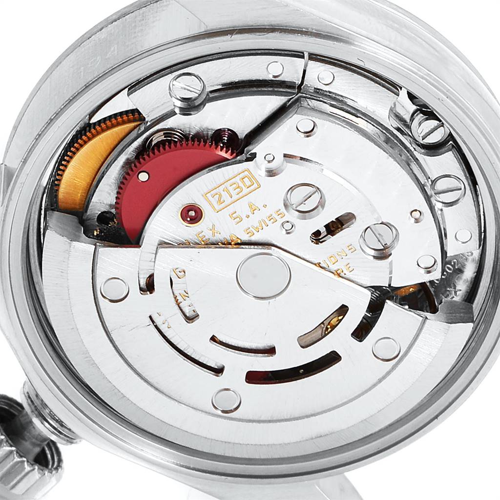 The image shows an internal view of the Oyster Perpetual Rolex watch, highlighting its movement and intricate components.