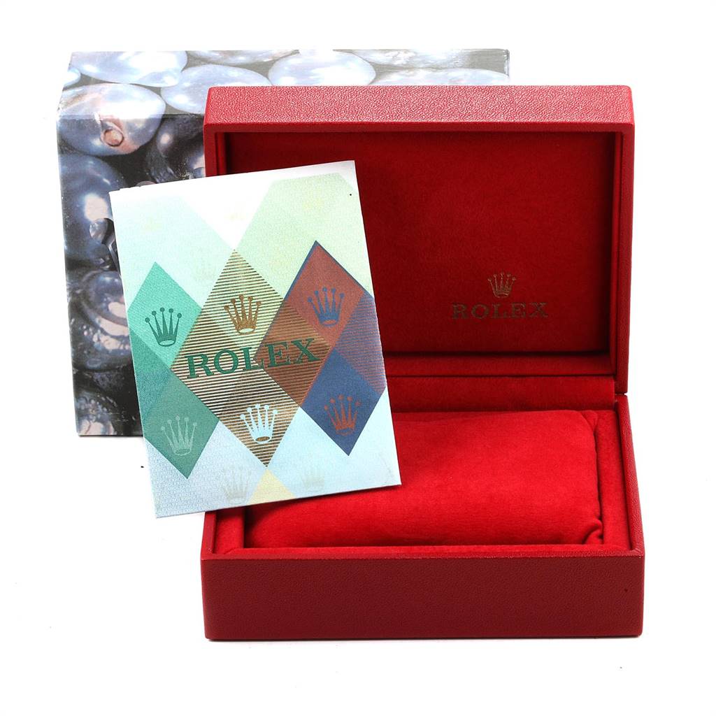 The image shows a red Rolex box for the Oyster Perpetual model and an accompanying brochure, viewed from the front.