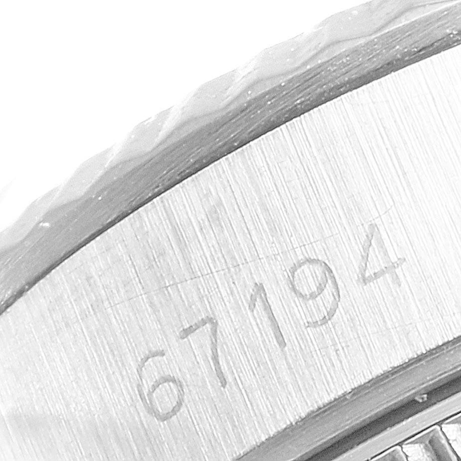 The close-up image shows the serial number engraving on the side of a Rolex Oyster Perpetual 67194 Women
s Stainless Steel White Dial 67194 Women
s Stainless Steel White Dial watch bezel.