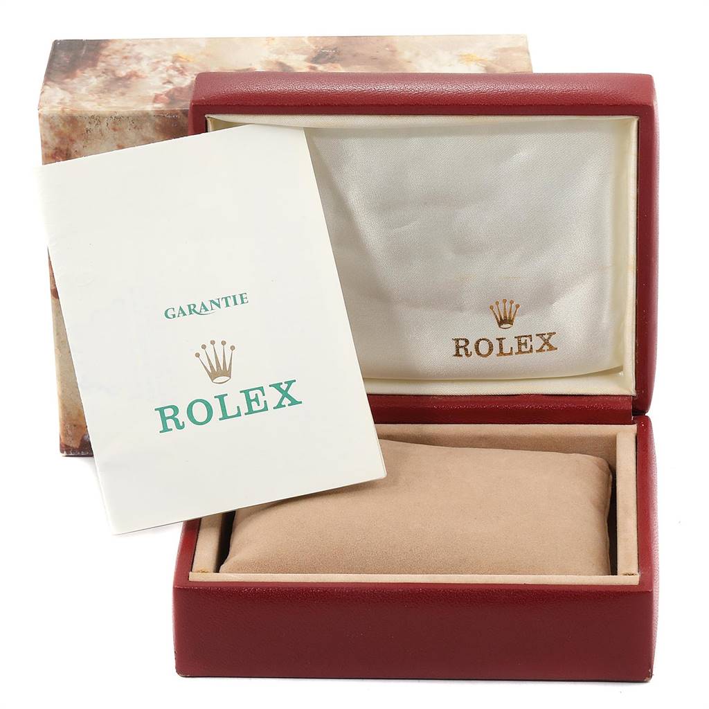 The image shows a Rolex Oyster Perpetual 67194 Women
s Stainless Steel White Dial 67194 Women
s Stainless Steel White Dial watch box with warranty card, viewed at an angle highlighting the box’s interior.