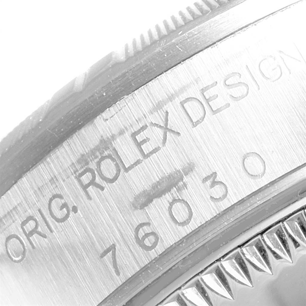 The image shows a close-up view of the side of the Rolex Oyster Perpetual 76030 Women's Stainless Steel Black Dial 76030 Women's Stainless Steel Black Dial watch, highlighting its engraved model number and design branding.