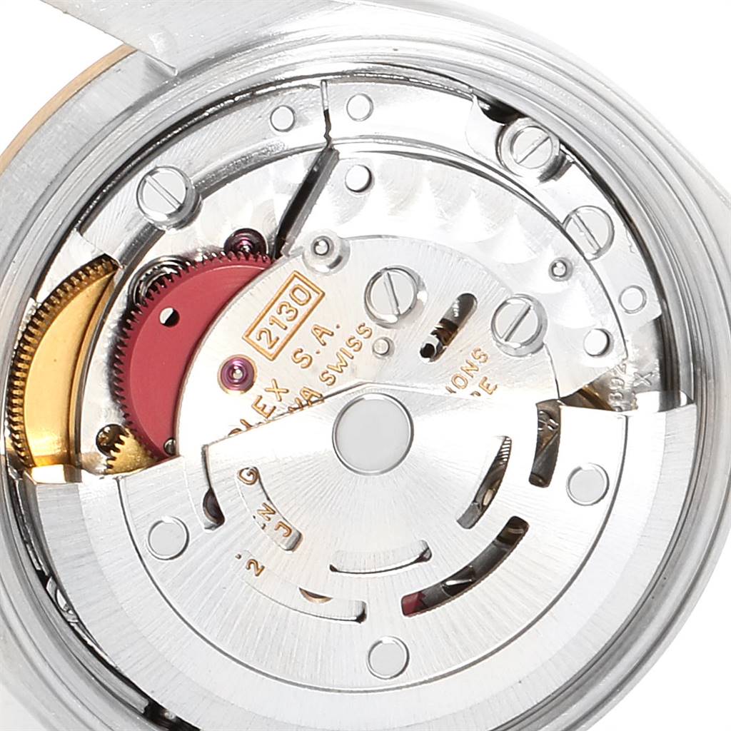The image shows the inner mechanical movement of the Rolex Oyster Perpetual 67183 Women
s Steel and Gold (two tone) Champagne Dial 67183 Women
s Steel and Gold (two tone) Champagne Dial watch, specifically the rotor and various components.