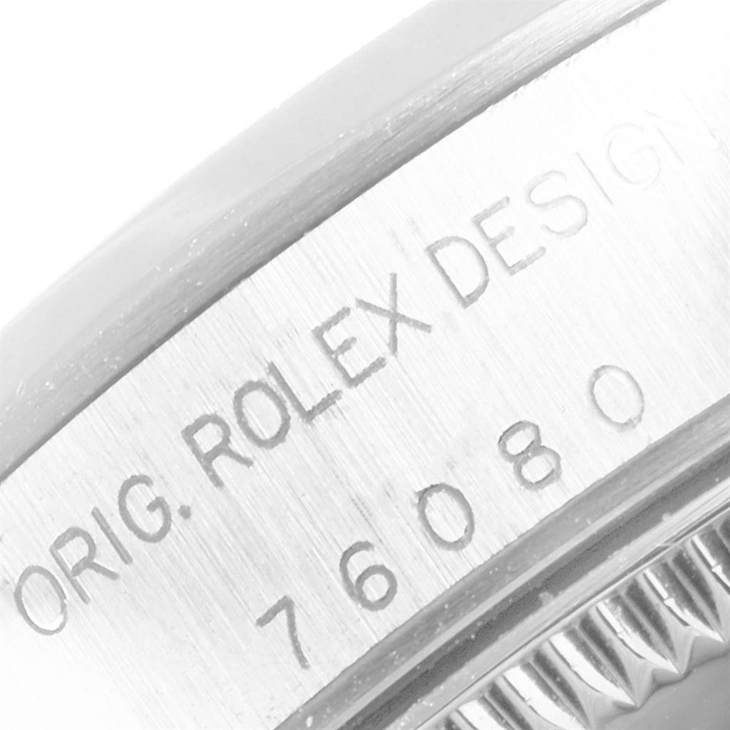 This close-up angle shows the engraved bezel of the Rolex Oyster Perpetual 76080 Women
s Stainless Steel White Dial 76080 Women
s Stainless Steel White Dial model.
